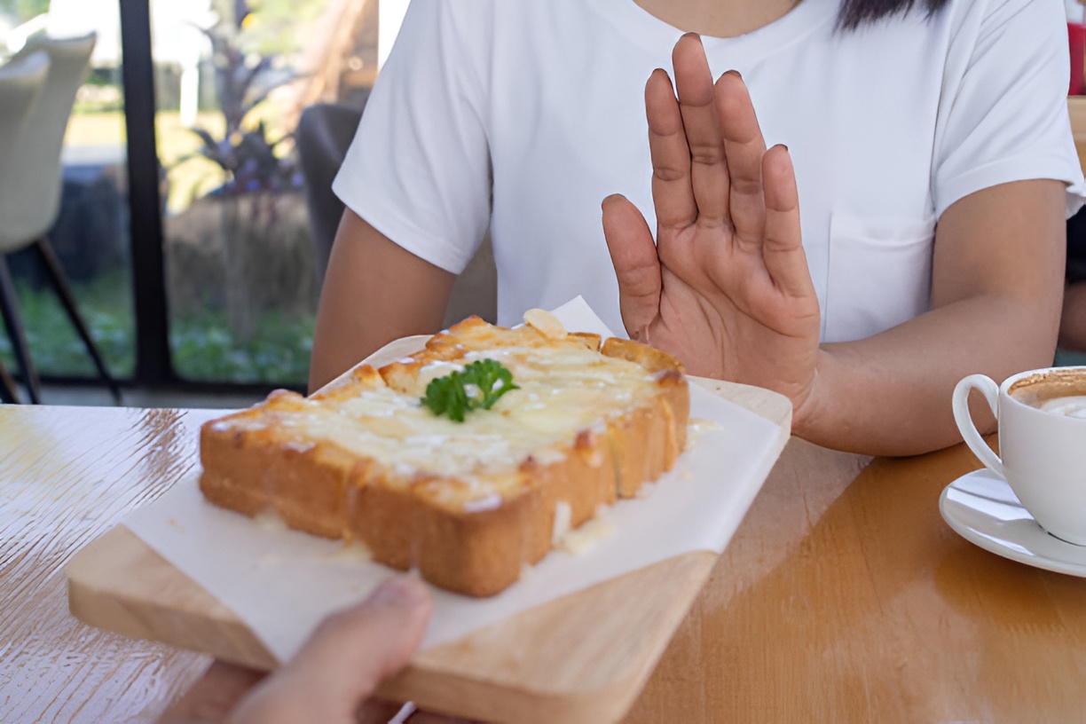 woman resisting a cheese sandwich